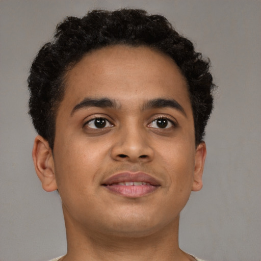 Joyful latino young-adult male with short  brown hair and brown eyes