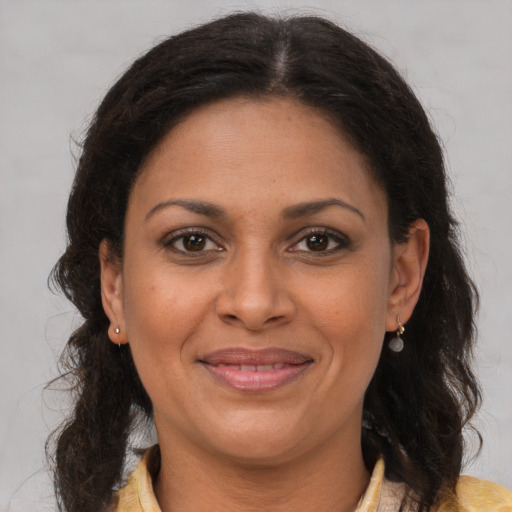 Joyful white adult female with medium  brown hair and brown eyes