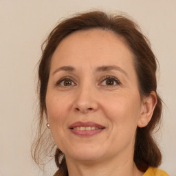 Joyful white adult female with medium  brown hair and brown eyes