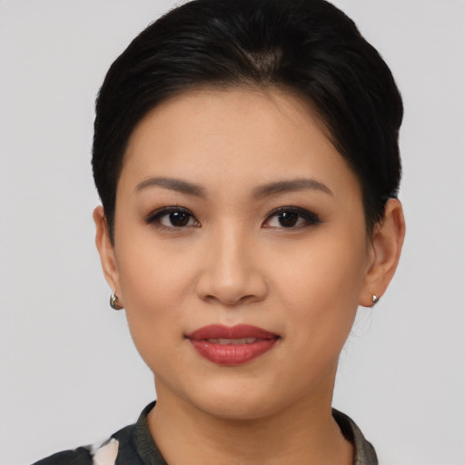 Joyful asian young-adult female with short  black hair and brown eyes