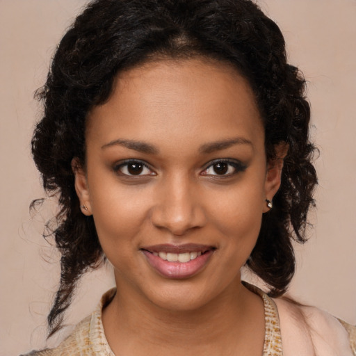 Joyful black young-adult female with long  brown hair and brown eyes