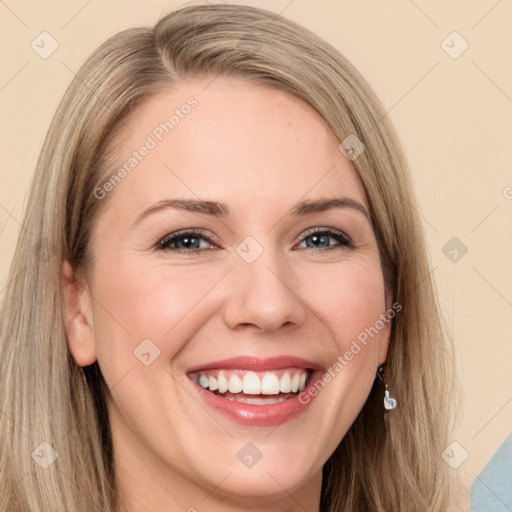 Joyful white young-adult female with long  brown hair and blue eyes