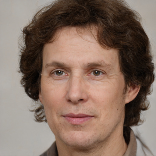 Joyful white adult male with medium  brown hair and grey eyes