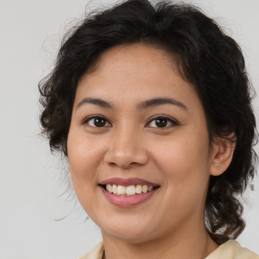 Joyful latino young-adult female with medium  brown hair and brown eyes