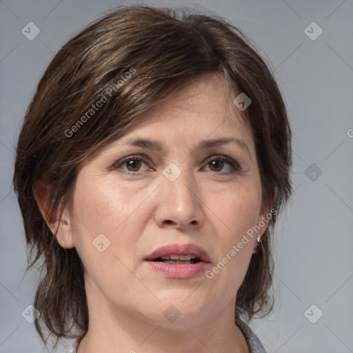 Joyful white adult female with medium  brown hair and brown eyes