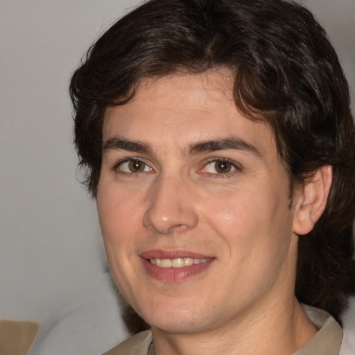 Joyful white adult male with medium  brown hair and brown eyes