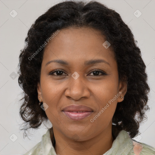 Joyful black adult female with medium  brown hair and brown eyes