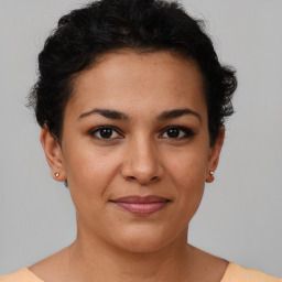 Joyful latino young-adult female with short  brown hair and brown eyes