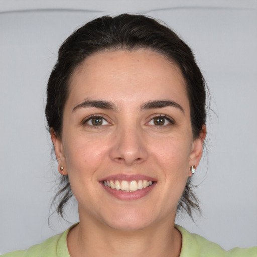 Joyful white young-adult female with medium  brown hair and brown eyes