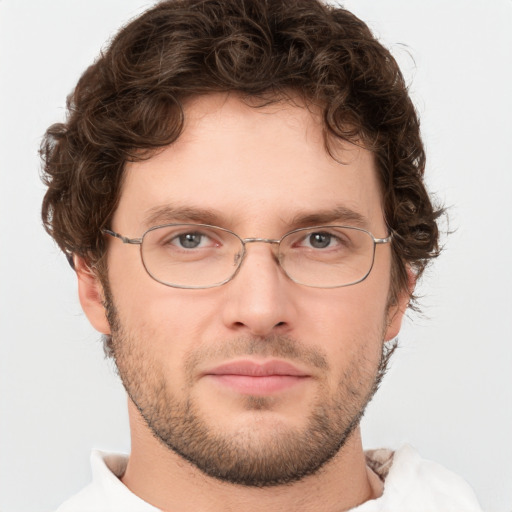 Joyful white young-adult male with short  brown hair and green eyes