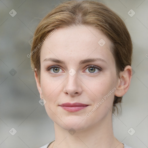 Joyful white young-adult female with medium  brown hair and green eyes