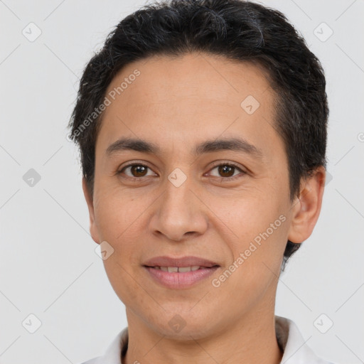 Joyful latino young-adult male with short  brown hair and brown eyes