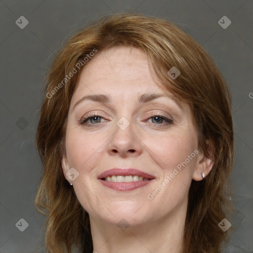 Joyful white adult female with medium  brown hair and grey eyes