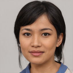 Joyful asian young-adult female with medium  black hair and brown eyes