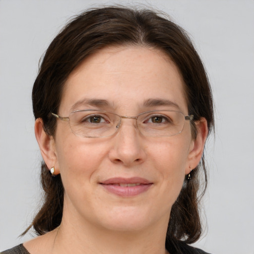 Joyful white adult female with medium  brown hair and brown eyes