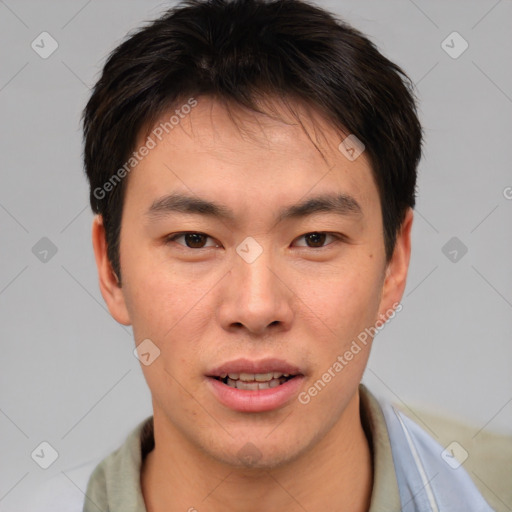 Joyful asian young-adult male with short  brown hair and brown eyes