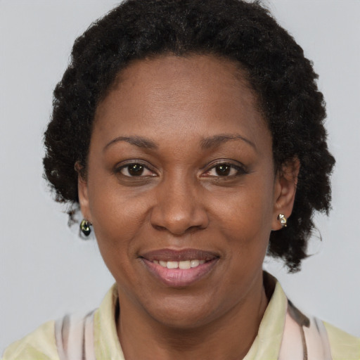 Joyful black adult female with short  brown hair and brown eyes