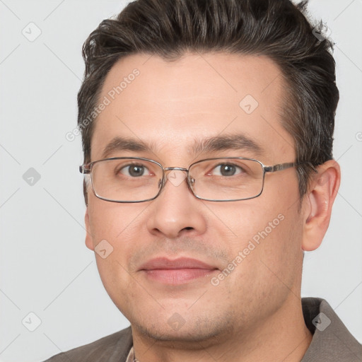 Joyful white adult male with short  brown hair and brown eyes