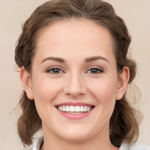 Joyful white young-adult female with medium  brown hair and green eyes