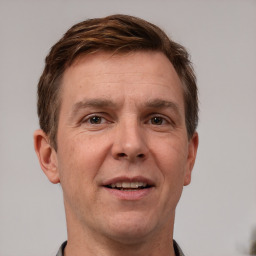 Joyful white adult male with short  brown hair and grey eyes