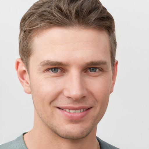 Joyful white young-adult male with short  brown hair and grey eyes