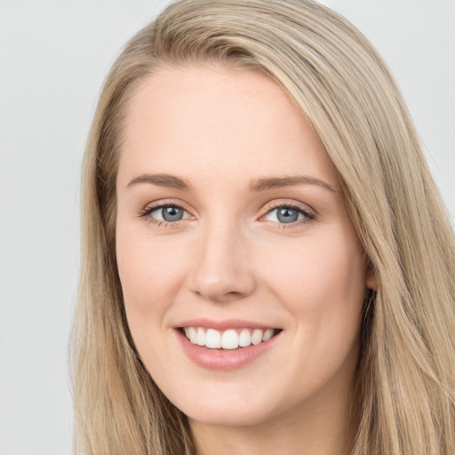 Joyful white young-adult female with long  brown hair and blue eyes