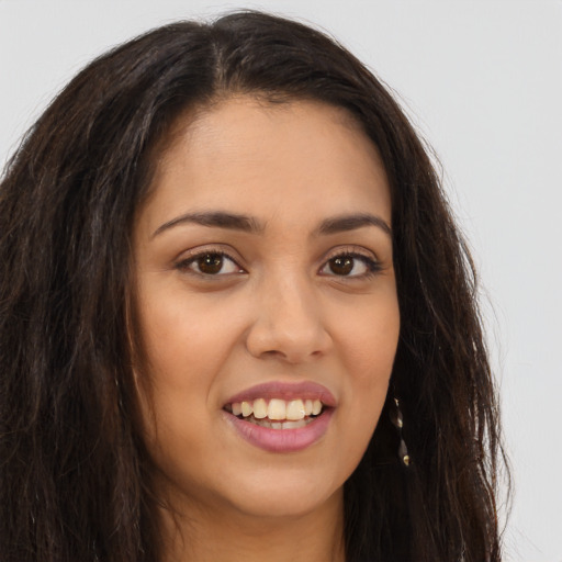 Joyful latino young-adult female with long  brown hair and brown eyes