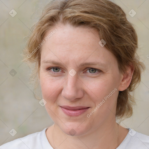 Joyful white adult female with medium  brown hair and blue eyes