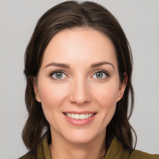 Joyful white young-adult female with medium  brown hair and green eyes