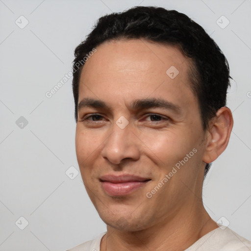 Joyful white young-adult male with short  black hair and brown eyes