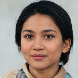 Joyful latino young-adult female with medium  black hair and brown eyes