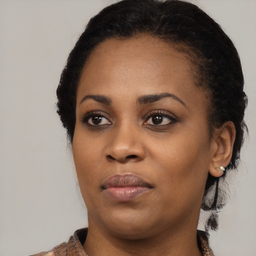 Joyful black young-adult female with medium  black hair and brown eyes
