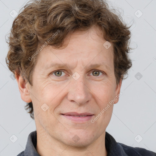 Joyful white adult male with short  brown hair and grey eyes