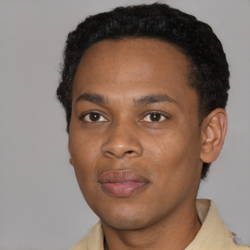 Joyful black young-adult male with short  black hair and brown eyes
