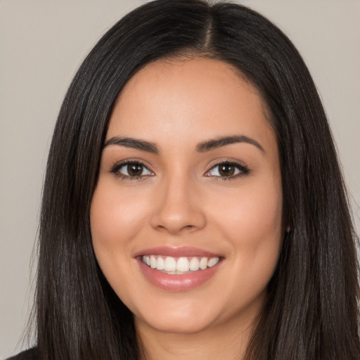 Joyful white young-adult female with long  black hair and brown eyes