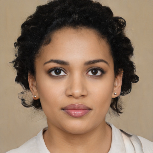 Joyful black young-adult female with medium  black hair and brown eyes
