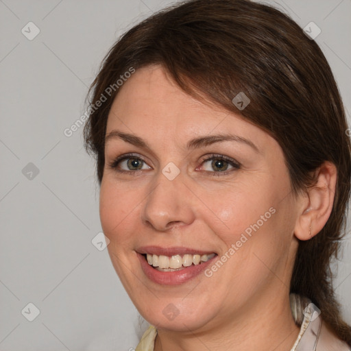 Joyful white adult female with medium  brown hair and grey eyes