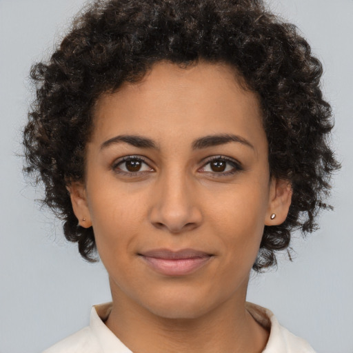 Joyful latino young-adult female with short  brown hair and brown eyes