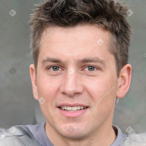 Joyful white adult male with short  brown hair and grey eyes