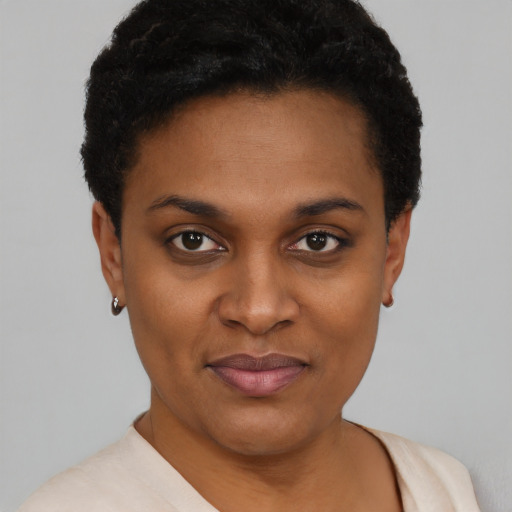 Joyful black young-adult female with short  black hair and brown eyes
