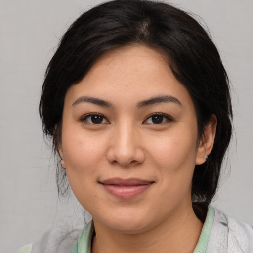 Joyful asian young-adult female with medium  brown hair and brown eyes