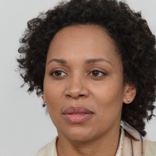 Joyful black adult female with medium  brown hair and brown eyes
