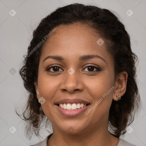 Joyful black young-adult female with medium  brown hair and brown eyes