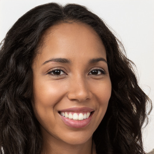 Joyful latino young-adult female with long  brown hair and brown eyes