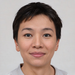 Joyful asian young-adult female with short  brown hair and brown eyes