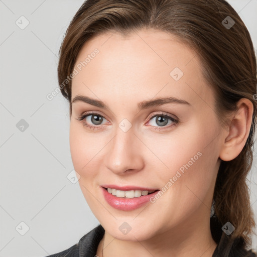 Joyful white young-adult female with medium  brown hair and blue eyes