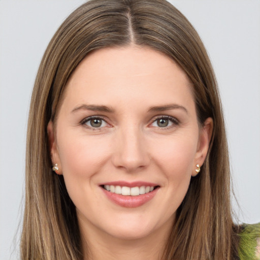 Joyful white young-adult female with long  brown hair and grey eyes