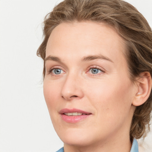 Joyful white young-adult female with medium  brown hair and blue eyes