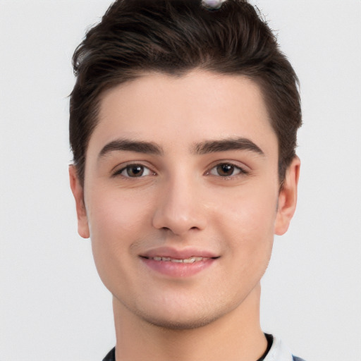 Joyful white young-adult male with short  brown hair and brown eyes