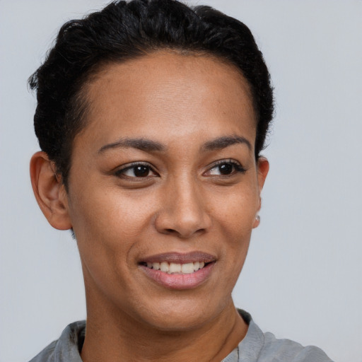 Joyful latino young-adult female with short  brown hair and brown eyes